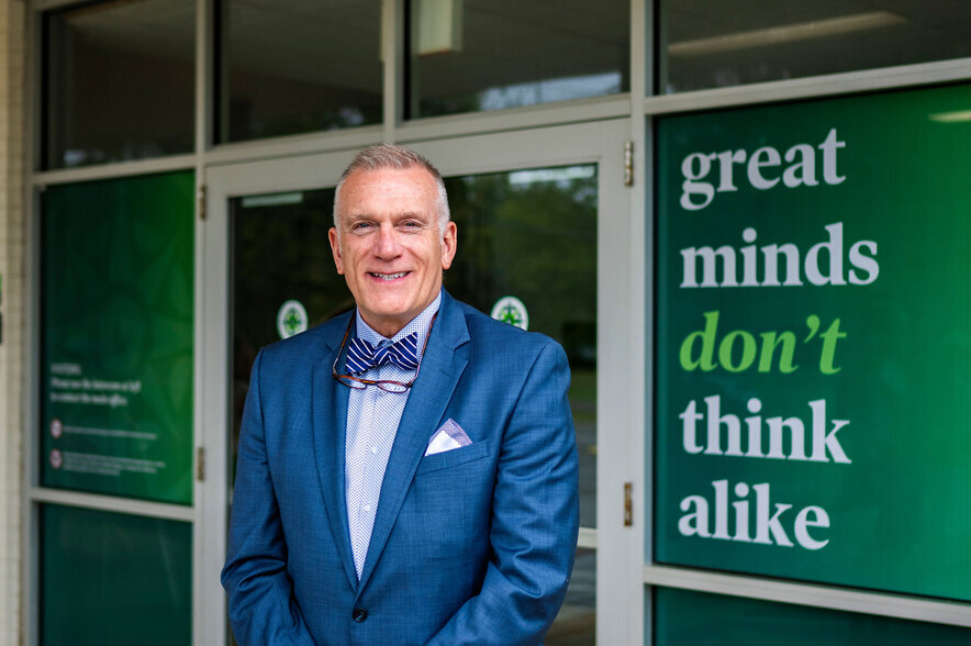 Head of School Doug Hamilton standing in front of Lower School entrance